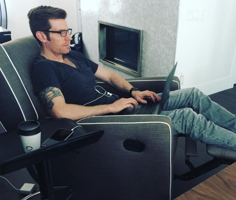marketcircle employee reclines in easy chair while coding on a laptop