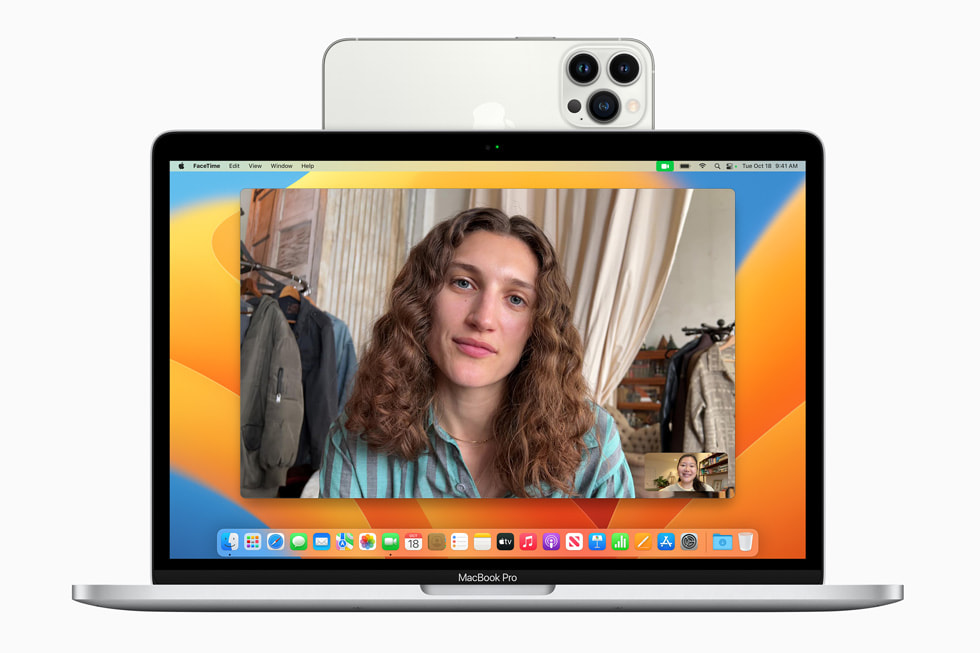 A MacBook with an iPhone attached being used as a Continuity Camera, which is one of the new Mac Ventura features.